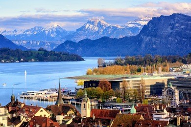 lucerne old town and culture center building on lake lucerne with snow covered alps mountains in background