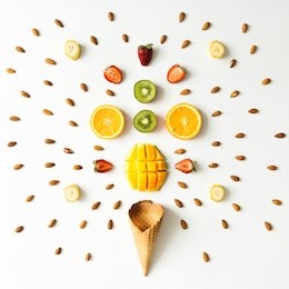 creative layout of fresh fruits, nuts and ice cream cone. flat lay. summer concept.