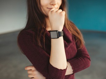 young female wearing smartwatch on her wrist. unrecognizable business woman and smartwatch
