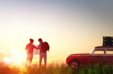 toward adventure! man and woman enjoying road trip. couple searches for a route on the map.