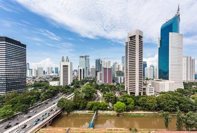 jakarta skyline with modern office towers and hotels along jalan sudirman in indonesia capital city business district.