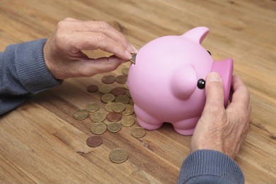 an elderly woman saves money