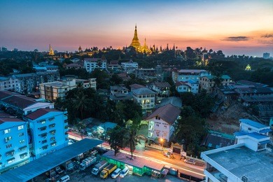 shwedagon pagoda during sunset time with yangong cityscape foreground myanmar