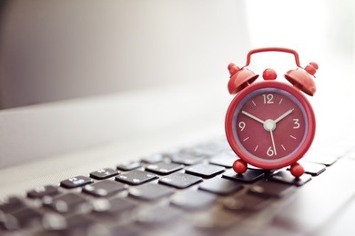 alarm clock on laptop concept for business deadline, schedule and urgency