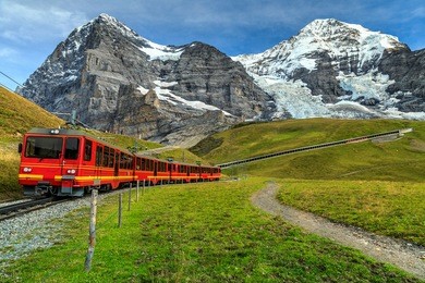 famous electric red tourist train coming down from the jungfraujoch station(top of europe) in kleine scheidegg,bernese oberland,switzerland,europe