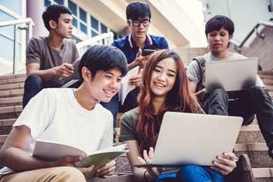 group of happy teen high school students outdoors