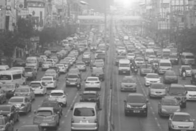 blurred traffic jam with smog on  the road in bangkok , thailand , black & white