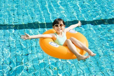 happy little girl having fun  in swimming pool