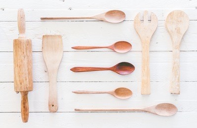 wooden kitchen utensils on white  wooden background