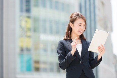 beautiful young asian woman using tablet computer