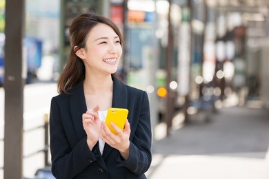 beautiful young asian woman who see a smart phone