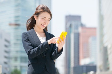 beautiful young asian woman who see a smart phone