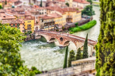 ancient roman bridge called ponte di pietra above the adige river in verona, italy. tilt-shift effect applied