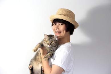 the asian woman holding tabby cat.