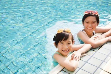 happy little girls having fun  in swimming pool