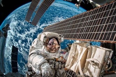 international space station and astronaut in outer space over the planet earth. elements of this image furnished by nasa.