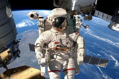 international space station and astronaut in outer space over the planet earth. elements of this image furnished by nasa.