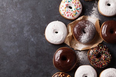 colorful donuts on stone table. top view with copy space