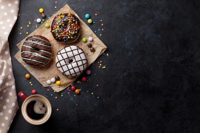 donuts and coffee on stone table. top view with copy space
