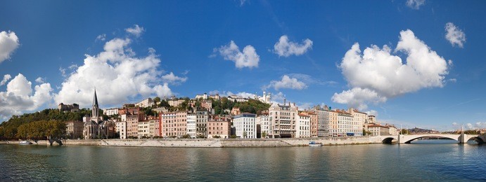 lyon, france - panoramic view of vieux lyon, saone river and fourviere. colorful houses. clear blue sky.