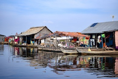 floating village houses on tonle sap lake in cambodia.
the houses are relocated during the year to gain optimal weather.  transport is by small boats, some powered by man, some by mechanical means.