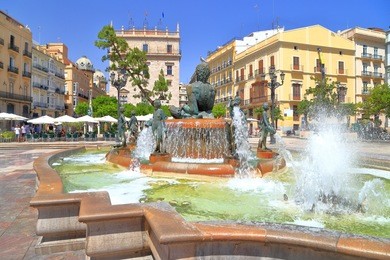 large square and turia fountain surrounded by historical buildings, plaza de la virgen, valencia, spain