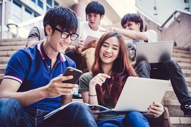 group of happy teen high school students outdoors