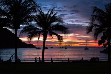 racha island is in the andaman sea of southern thailand. tourists shall enjoy the beach with fine white sand and clear blue sea. patok bay of the racha yai, is the best spot for watching sunset.