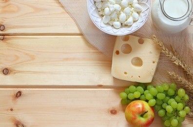 image of dairy products and fruits on wooden background. symbols of jewish holiday - shavuot
