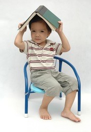 little boy playing with book