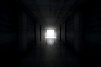 a 3d rendering of a distant look down a dark stadium sports tunnel to enter a lit arena in the distance