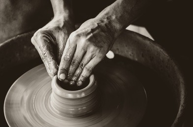 artisan hands making clay pot