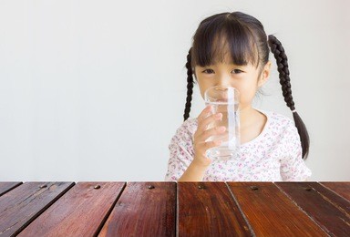 look out from the table, asian girl drink water as background.