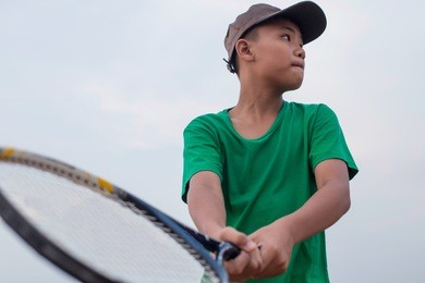 asian boy playing tennis