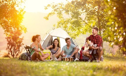 young friends have good time on camping trip, relaxing vacation with fun