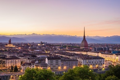 cityscape of torino (turin, italy) at sunsetwith colorful clear sky. the mole antonelliana towering on the city.