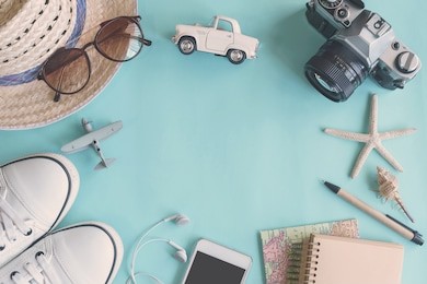 outfit of traveler on green background with copy space, travel concept