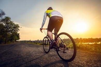 athletic cyclist on the road in a beautiful area in the afternoo