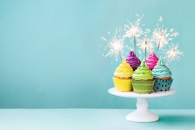 cupcakes on a cake stand with sparklers