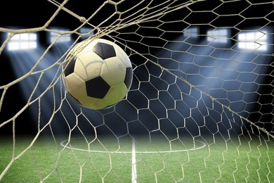 soccer ball in goal with spotlight