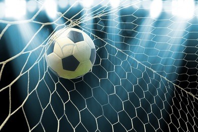 soccer ball in goal with spotlight