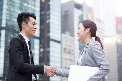 business people team meeting with computer in front of the office building, shot in hong kong, asian