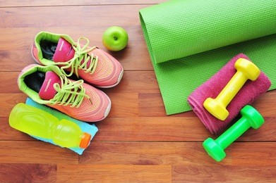 shoes and water with set for sports activities on wooden floor.