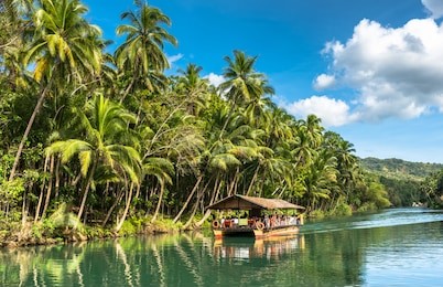 traditional raft boat on a jungle green river loboc at bohol island of philippines