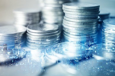 double exposure of city and rows of coins for finance and banking concept