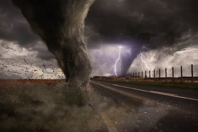 view of a large tornado destroying a road