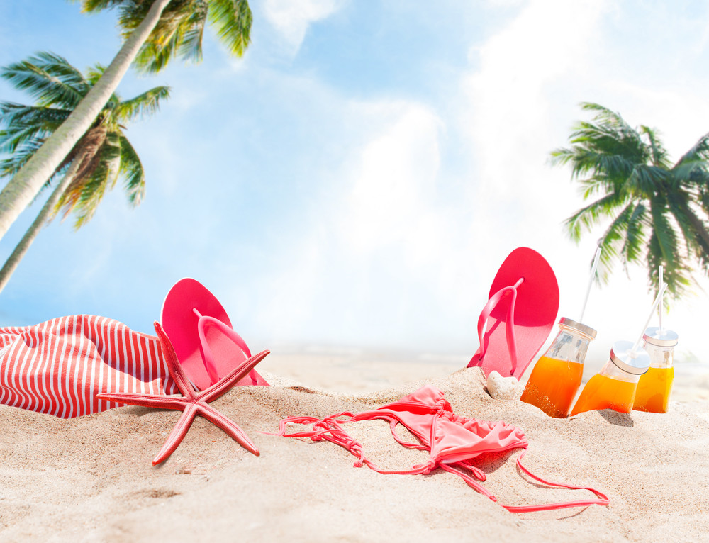holiday accessories on sand beach orange juice bikini slippers sea star sunny summer day relax concept art collage palm background