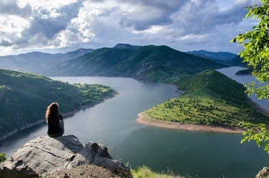 woman meditating relaxing alone travel healthy lifestyle concept lake and mountains sunny landscape on background outdoor