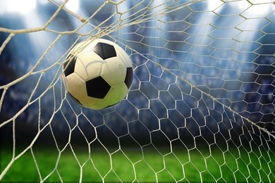 soccer ball in goal with spotlight