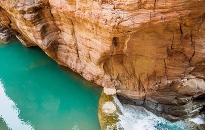 the yuntaishan geo park xiuwu county, jiaozuo, henan province of china. the view displays the rocks formations with turquoise pond and waterfall along the narrow canyon.  